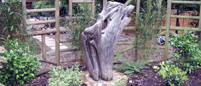 A driftwood sculpture in a resident's garden